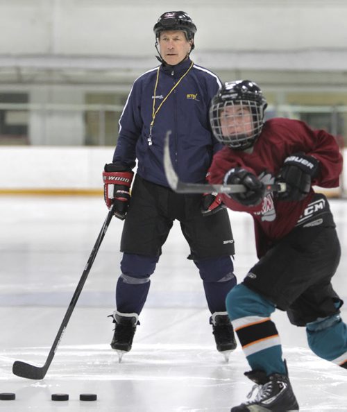 Morris Lukowich, who played for the WHA and NHL Jets, has a company called "Max Goal Scoring" that he takes on the road to teach kids the art of scoring. Geoff Kirbyson story.  Morris goes through drills with a young hockey player. Wayne Glowacki / Winnipeg Free Press May 22 2014