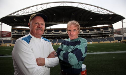 Football coaches Bill Petrie and Ron Gustafson (left) pose at Investors Group Field. The two will face off saturday as coaches in the "Senior Bowl" See Paul Weicik's story. May 22, 2014 - (Phil Hossack / Winnipeg Free Press)