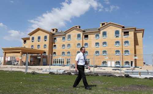 Selkirk mayor Larry Johannson stands in front of the under-construction Canalta Hotel on Manitoba Avenue in Selkirk on Fri., May 23, 2014. ItÄôs the first hotel being built in the city for almost half a century. Photo by Jason Halstead/Winnipeg Free Press
