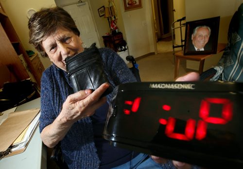 Viola Dufresne shows off her "Granny Cam" hidden in a digital clock. The 82 year old used the device to catch care worker red handed emtying cash from the purse she holds in her other hand. See Mike MacIntyre's story. May 23, 2014 - (Phil Hossack / Winnipeg Free Press)