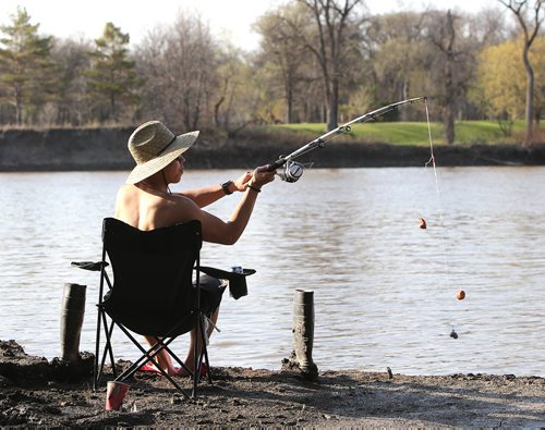 John Haw does some evening fishing in St. Vital Park on Fri., May 23, 2014. Photo by Jason Halstead/Winnipeg Free Press