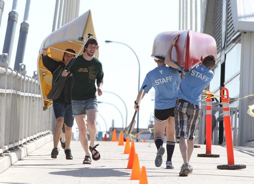 Jon Bruckshaw (front left) and Julian Sigurdson of Team Copeland Counterstrike and other competitors portage their canoes over Esplanade Riel Bridge during the first-ever Great Manitoba Portage at Festival Park at The Forks on Sat., May 24, 2014. The event was a fundraiser for the Manitoba Camping AssociationÄôs Sunshine Fund. Photo by Jason Halstead/Winnipeg Free Press