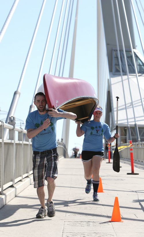 Bob Black and Amy Weston of Team Camp Douglas portage their canoe over Esplanade Riel Bridge during the first-ever Great Manitoba Portage at Festival Park at The Forks on Sat., May 24, 2014. The event was a fundraiser Manitoba Camping AssociationÄôs Sunshine Fund. Photo by Jason Halstead/Winnipeg Free Press