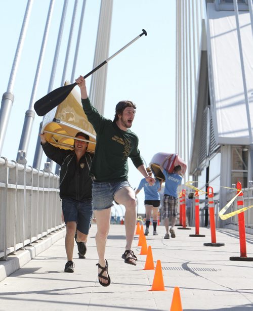 Jon Bruckshaw (front) and Julian Sigurdson of Team Copeland Counterstrike portage their canoe over Esplanade Riel Bridge during the first-ever Great Manitoba Portage at Festival Park at The Forks on Sat., May 24, 2014. The event was a fundraiser for the Manitoba Camping AssociationÄôs Sunshine Fund. Photo by Jason Halstead/Winnipeg Free Press