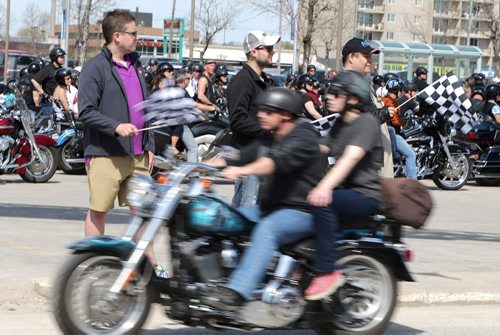 Spectators wave checkered flags as motorcyclists left Polo Park to take part in the annual Ride For Dad on Sat., May 24, 2014. Thousands took part in the ride from Winnipeg to Selkirk that also involved lunch and poker run while helping to raise money to fight prostate cancer. Photo by Jason Halstead/Winnipeg Free Press