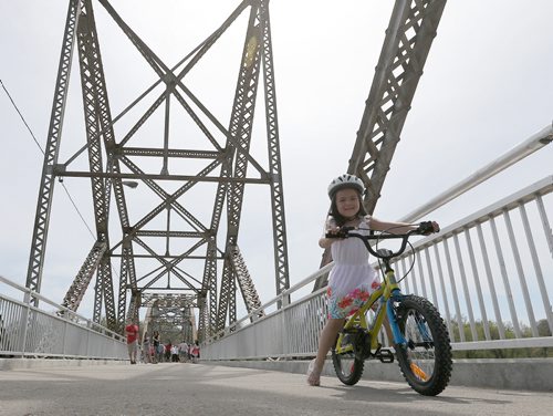 Kaia Sigurdson, 5, bikes across Elm Park Bridge (the span connecting Bridge Drive-In with Kingston Row). The 100th anniversary of the bridge was celebrated on Sat., May 24, 2014.  Photo by Jason Halstead/Winnipeg Free Press