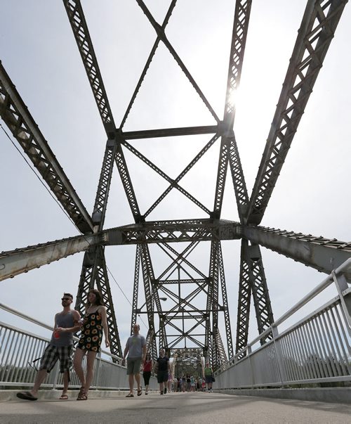 People stroll across Elm Park Bridge (the span connecting Bridge Drive-In with Kingston Row). The 100th anniversary of the bridge was celebrated on Sat., May 24, 2014.  Photo by Jason Halstead/Winnipeg Free Press