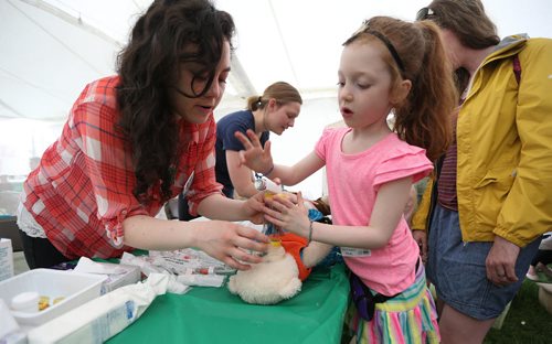 U of M pharmacy student Karen Schellenberg helps Luca Morin, 6, with her bear 'Hydrogena' at the 28th annual Teddy BearsÄô Picnic at Assiniboine Park on Sun., May 25, 2014. The event is a fundraiser for the ChildrenÄôs Hospital Foundation of Manitoba. Photo by Jason Halstead/Winnipeg Free Press