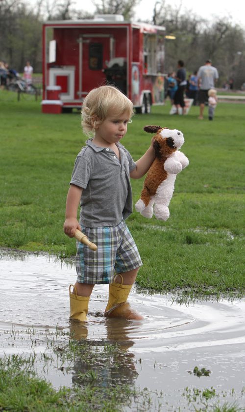 Dylan Gauthier, 3, walks through a puddle with his stuffed toy at the 28th annual Teddy BearsÄô Picnic at Assiniboine Park on Sun., May 25, 2014. The event is a fundraiser for the ChildrenÄôs Hospital Foundation of Manitoba. Photo by Jason Halstead/Winnipeg Free Press