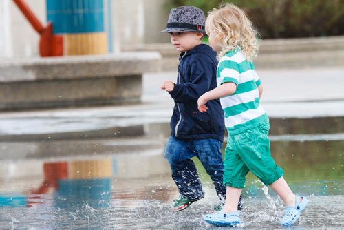 20140525 -  (from left) Owen Watson (3) and Emma Gyd¾© (2) runs through puddles at the Forks Sunday morning. Darcy Finley / Winnipeg Free Press