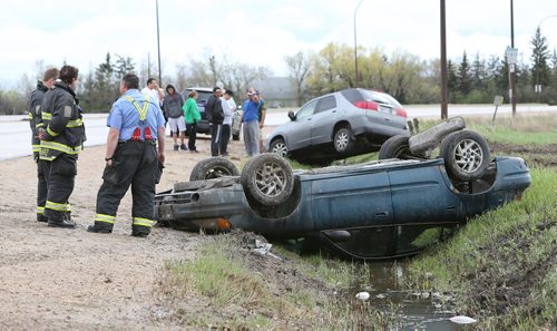 Firefighters work at the scene of a two-vehicle accident during the afternoon on Sun., May 25, 2014, on McPhillips Street just south of the Perimeter Highway. There were only minor injuries sustained by occupants of the vehicles. Photo by Jason Halstead/Winnipeg Free Press