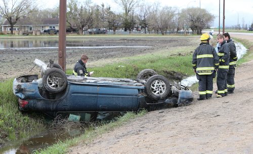 Firefighters work at the scene of a two-vehicle accident during the afternoon on Sun., May 25, 2014, on McPhillips Street just south of the Perimeter Highway. There were only minor injuries sustained by occupants of the vehicles. Photo by Jason Halstead/Winnipeg Free Press