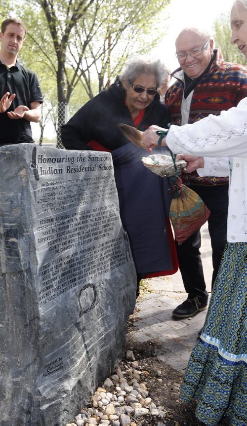 Stdup -FORKS - Residential School survivors Ted Fontaine and Anne Callahan  wittnes the smudging of the monument by elder Velma  Orvis (right) - TRIBUTE HONORS SURVIVORS OF RESIDENTIAL SCHOOLS WINNIPEGÄîThe historic meeting place for Indigenous, Metis and non Indigenous people will take on even greater significance at the Forks, when a monument is unveiled as a tribute to those who attended the Residential Schools in Canada.According to the national Anglican Church website, during the century following Confederation, there were an estimated 80 church run, government funded Indian Residential Schools. The purpose of the schools was to assimilate Indigenous children . in a Canadian apology and the birth of the Truth and Reconciliation Commission in Canada. One of the elders who was a survivor called on the federal government to erect a monument to those who attended Residential Schools .Before his death five years ago, Elder Nelson James from Roseau River suggested such a monument needed to be in a public place where many could see and gain an understanding of the Indigenous Canadians who went to the schools. May 26 2014 / KEN GIGLIOTTI / WINNIPEG FREE PRESS