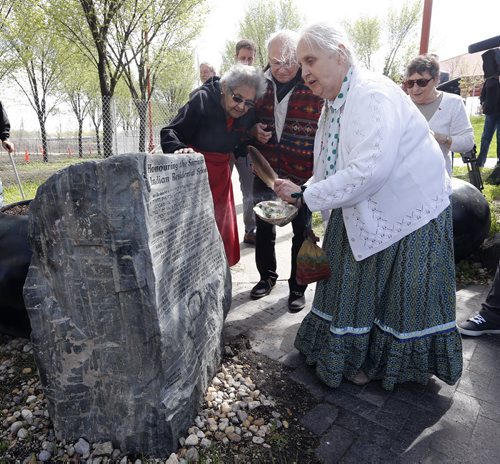Stdup -LtoR ,Residential School survivors Anne Callahan  Ted Fontaine  witttnes the smudging of the monument by elder Velma  Orvis (right)  TRIBUTE HONORS SURVIVORS OF RESIDENTIAL SCHOOLS WINNIPEGÄîThe historic meeting place for Indigenous, M¾©tis and non Indigenous people will take on even greater significance at the Forks, when a monument is unveiled as a tribute to those who attended the Residential Schools in Canada.According to the national Anglican Church website, during the century following Confederation, there were an estimated 80 church run, government funded Indian Residential Schools. The purpose of the schools was to assimilate Indigenous children . in a Canadian apology and the birth of the Truth and Reconciliation Commission in Canada. One of the elders who was a survivor called on the federal government to erect a monument to those who attended Residential Schools .Before his death five years ago, Elder Nelson James from Roseau River suggested such a monument needed to be in a public place where many could see and gain an understanding of the Indigenous Canadians who went to the schools. May 26 2014 / KEN GIGLIOTTI / WINNIPEG FREE PRESS