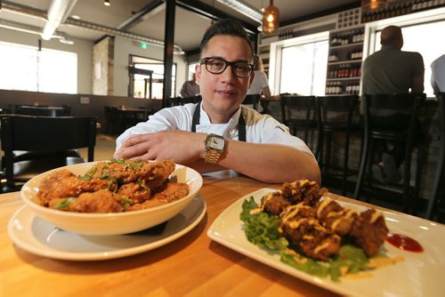 Executive chef/partner Norm Pastorin shows off chicken wings and steak bits at the Cornerstone Bar and Restaurant at the corner of Osborne Street and River Avenue on Mon., May 26, 2014. RE: restaurant review Photo by Jason Halstead/Winnipeg Free Press