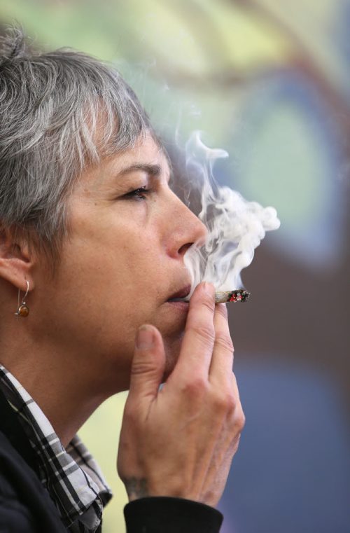 Medical marijuana patient Holly Plouffe smokes at the Medical Marijuana Lounge and Resource Centre at Vapes on Main on Mon., May 26, 2014. Former police officer Bill VanderGraaf and two partners have opened up a lounge for medical marijuana users at 1402 Main St. RE: Larry Kusch story Photo by Jason Halstead/Winnipeg Free Press