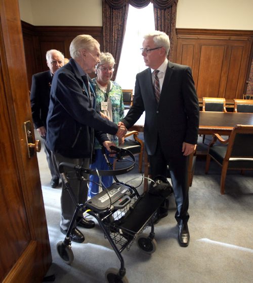 Bill McGowan speaks with Premier Greg Selinger Monday afternoon at the Legislature. Two other veterans of the Battle Normandy will accompany Selinger to Europe for the anniversary June 4. Invited, McGowan is unable to go. See Bruce Owen story. May 26, 2015 - (Phil Hossack / Winnipeg Free Press)