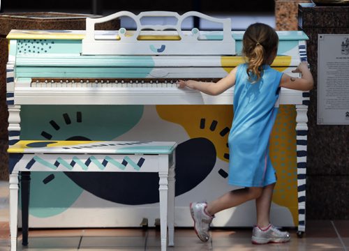 Jorja Geal age 3 plays piano at Portage Place left during Juno Week  .Downtown pianos update , Piano at Portage Place . story by Jessica Botelbo-Urbanski  May 27 2014 / KEN GIGLIOTTI / WINNIPEG FREE PRESS
