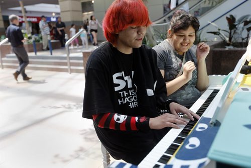 left Jason Beardy  and cousin Monica Beardy plays piano at Portage Place left during Juno Week  .Downtown pianos update , Piano at Portage Place . story by Jessica Botelbo-Urbanski  May 27 2014 / KEN GIGLIOTTI / WINNIPEG FREE PRESS