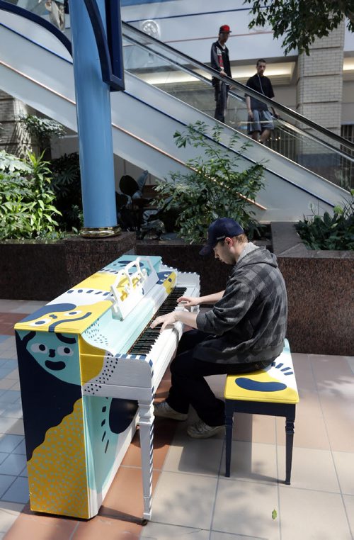 Marc Tugby plays  piano at Portage Place left during Juno Week  .Downtown pianos update , Piano at Portage Place . story by Jessica Botelbo-Urbanski  May 27 2014 / KEN GIGLIOTTI / WINNIPEG FREE PRESS