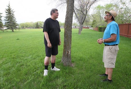 Crestview residents are upset with Coun. Grant Nordmans plans to convert Voyageur Park into an off-leash dog park. Craig Boan and  John Bazarkewich, right , discuss park Thursday.Aldo Santin story- May 21, 2014   (JOE BRYKSA / WINNIPEG FREE PRESS)