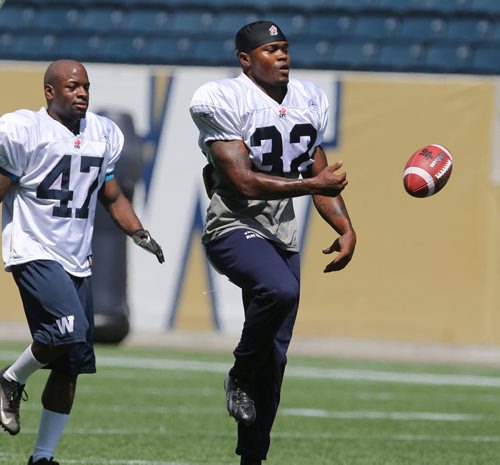 Winnipeg Blue Bombers RB Nic Grigsby (right) takes part in football practice at Investors Group Field on Thurs., May 29, 2014. Photo by Jason Halstead/Winnipeg Free Press