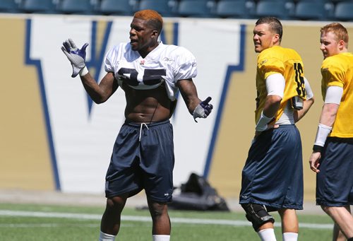 Winnipeg Blue Bombers RB Kevin Smith (left) takes part in football practice at Investors Group Field on Thurs., May 29, 2014. Photo by Jason Halstead/Winnipeg Free Press