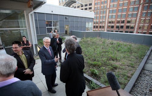 Premier Greg Selinger chats with guests after a brief awards ceremony on the rooftop of MEC Friday Morning. See release? May 30, 2014 - (Phil Hossack / Winnipeg Free Press)