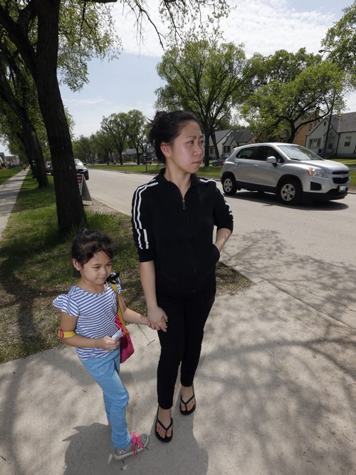 mother Einalice Uminge with her daughter Chole age 5 kindergarden student outside Inkster School , Inkster School parents favour reduction of speed but would like to see Inkster Blvd reduced also . REDUCED SPEED ZONES Äî A report that proposes a new bylaw to establish reduced-speed school zones in Winnipeg will be considered Tuesday by the Committee on Infrastructure Renewal and Public Works. If approved by the city, maximum speed limits of 30 km/h would be set up around 171 Winnipeg schools, in effect from 7 a.m. to 5:30 p.m., Monday to Friday during the months of September to June. Story Santin Rollason  May 30 2014 / KEN GIGLIOTTI / WINNIPEG FREE PRESS