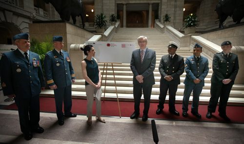 Deanne Crothers and Premier Greg Selinger announce a new post mark on government envelopes to honor veterans. See release. May 30, 2014 - (Phil Hossack / Winnipeg Free Press)