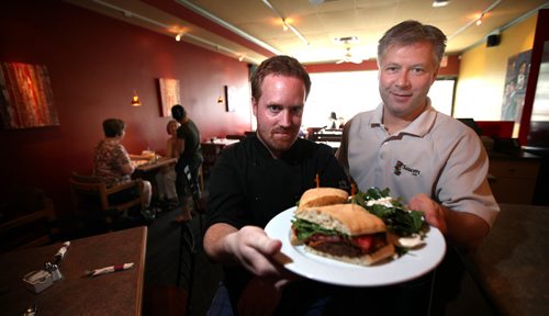 Saucers owners Stuart Deacon (left) and Dave Shultz show off a Bisobn Sandwich one of the house specialties, See Dave Sanderson story. May 30, 2014 - (Phil Hossack / Winnipeg Free Press)
