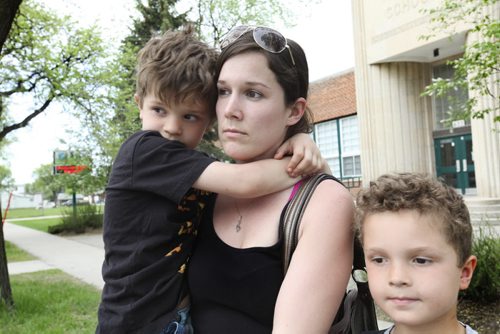 Nola Hunstad holds her youngest son Ethan  as she leaves Inkster School where her three sons, Ethan - 6yrs, Nick - 8yrs and Alex - 9yrs (grey shirt) attend.  She makes sure she picks them up from school everyday because she is worried about them being hit by cars while crossing Inskter Blvd.  Her oldest son Alex was almost hit by a car this past winter but she managed to pull him out of the way.  See story on School traffic zones by Kevin Rollason. Ruth Bonneville / Winnipeg Free Press