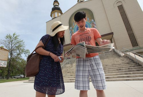 Jenny Yee and Kai Wu check out where else they would like to explore after visiting Ukrainian Orthodox Metropolitan Cathedral of the Holy Trinity on Main Street during the annual Open Doors Wpg event Saturday,   May 31, 2014 Ruth Bonneville / Winnipeg Free Press