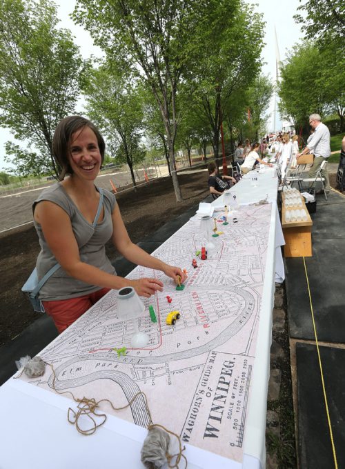 Jane Stewart prepares her and her friends' table for Table for 1200, on the Esplanade Riel Bridge on Sat., May 31, 2014. The event is an initiative of StorefrontMB and 5468796 Architecture, and was created to highlight Winnipeg's emerging design scene by bringing together architecture, design and the culinary arts. The prairie-themed food for the Äòpop upÄô outdoor dining experience will be provided by local chefs Mandel Hitzer from Deer + Almond and Joe Kalturnyk from RAW Gallery, along with Ben Kramer from Diversity Food Services. Photo by Jason Halstead/Winnipeg Free Press