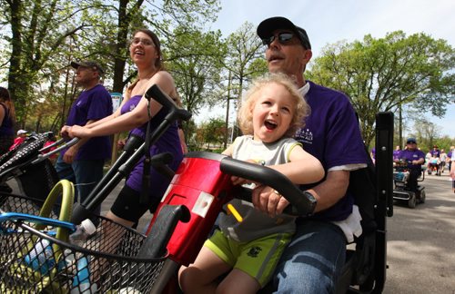 Three year old Joshua Stephenson is all smiles as he rides on a scooter with his granddad Rudy Sawatsky during the annual walk for Als, a 5k walk through Assiniboine Park to raise funds and awareness for the Altzheimer's Society.  Standup Photo.  May 31, 2014 Ruth Bonneville / Winnipeg Free Press