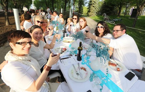 Diners at the Ethero Events and Management Table enjoy themselves at the Table for 1200 event on the Esplanade Riel Bridge on Sat., May 31, 2014. The event was an initiative of StorefrontMB and 5468796 Architecture, and was created to highlight Winnipeg's emerging design scene by bringing together architecture, design and the culinary arts. The prairie-themed food for the Äòpop upÄô outdoor dining experience was provided by local chefs Mandel Hitzer from Deer + Almond and Joe Kalturnyk from RAW Gallery, along with Ben Kramer from Diversity Food Services. Photo by Jason Halstead/Winnipeg Free Press