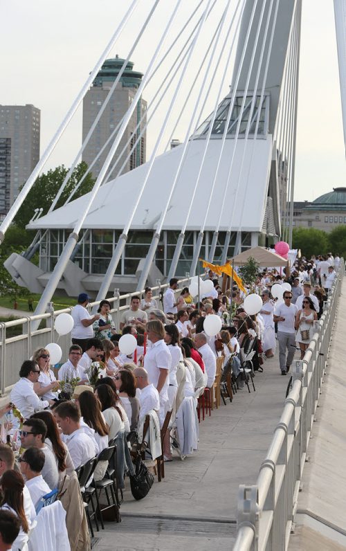 Diners enjoy themselves at the Table for 1200 event on the Esplanade Riel Bridge on Sat., May 31, 2014. The event was an initiative of StorefrontMB and 5468796 Architecture, and was created to highlight Winnipeg's emerging design scene by bringing together architecture, design and the culinary arts. The prairie-themed food for the Äòpop upÄô outdoor dining experience was provided by local chefs Mandel Hitzer from Deer + Almond and Joe Kalturnyk from RAW Gallery, along with Ben Kramer from Diversity Food Services. Photo by Jason Halstead/Winnipeg Free Press