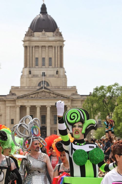 A participant shoots a selfie in the 2014 Pride Parade along Memorial Blvd in front of the Manitoba Legislative Building Sunday afternoon.  140601 June 01, 2014 Mike Deal / Winnipeg Free Press