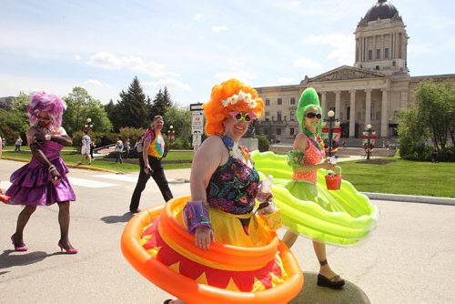 Participants in the 2014 Pride Parade walk along Memorial Blvd in front of the Manitoba Legislative Building Sunday afternoon.  140601 June 01, 2014 Mike Deal / Winnipeg Free Press