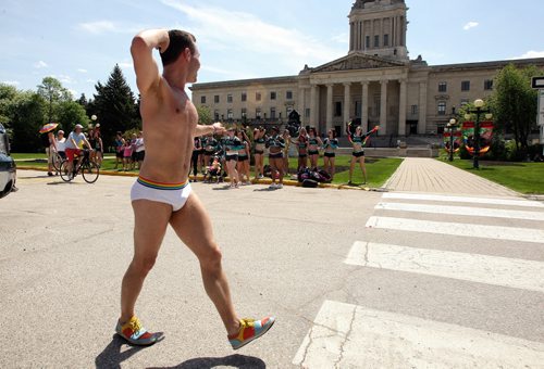 Participants in the 2014 Pride Parade walk along Memorial Blvd in front of the Manitoba Legislative Building Sunday afternoon.  140601 June 01, 2014 Mike Deal / Winnipeg Free Press