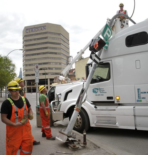 Light Work. A city crew starts to remove a traffic light standard that was hit by a semi trailer that was making the corner off Smith Street on to York Ave. Monday morning. Wayne Glowacki/Winnipeg Free Press June 2 2014