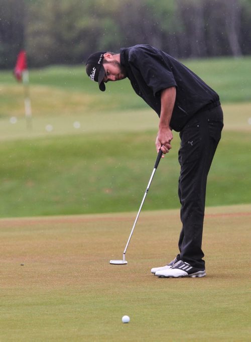 Bryce Barr a first year medical student at the University of Manitoba and who is in his fourth year on the UofM golf team putts in the rain during the practice round for the University Golf Championship being held at Southwood this year.  140602 June 02, 2014 Mike Deal / Winnipeg Free Press