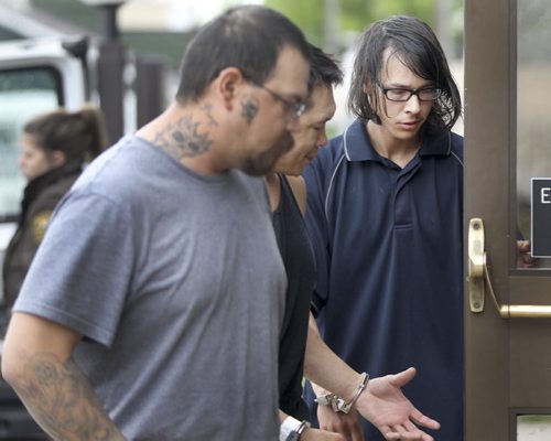 Jason Conway, 21, of MacGregor, Manitoba, right, is led into the provincial court house Monday in Portage la Prairie, Manitoba- He has been charged with first-degree murder in connection to the death of 96 year old Niels "Arne" Nielsen, who was reported dead last month. See James Turner story- June 02, 2014   (JOE BRYKSA / WINNIPEG FREE PRESS)