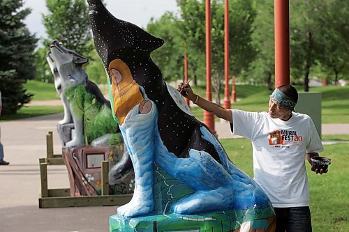 BORIS MINKEVICH / WINNIPEG FREE PRESS  070710 Local artist Patrick Ross does some finishing touches on the wolf that he was commisioned to paint.