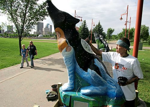 BORIS MINKEVICH / WINNIPEG FREE PRESS  070710 Local artist Patrick Ross does some finishing touches on the wolf that he was commisioned to paint.