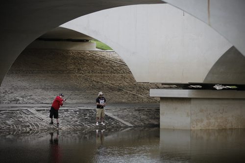 June 2, 2014 - 140602  -  Jordan Jeffs (L) and his friend Brett Robertson fish the La Salle River under the St. Norbert Bridge Monday, June 2, 2014. The friends say the fishing is good for walleye and pike. They say they caught a 26 inch pike on Saturday. John Woods / Winnipeg Free Press