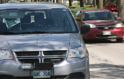 A mobile photo radar unit on Burrows Ave in school zone Tuesday-Operator uses handheld device to capture traffic coming from other direction- His vehicle can capture tickets from both directions- See Aldo Santin story- June 03, 2014   (JOE BRYKSA / WINNIPEG FREE PRESS)