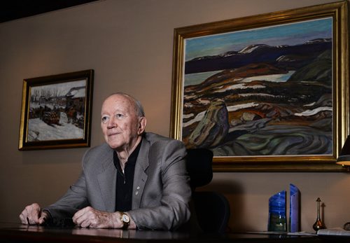 Jim Burns sits in front of Group of Seven's Iron Ore Country Labrador, 1938 painting in his office. He says the office on the 26th floor of the Richardson Building has the best art collection in town. Sarah Taylor / Winnipeg Free Press