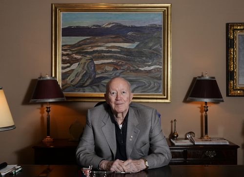 Jim Burns sits in front of Group of Seven's Iron Ore Country Labrador, 1938 painting in his office. He says the office on the 26th floor of the Richardson Building has the best art collection in town. Sarah Taylor / Winnipeg Free Press
