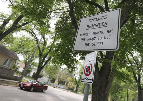 A Sunday cycling regulation sign photographed on Wolseley Avenue on Wed., June 4, 2014. Changes are coming to Sunday bike routes. Photo by Jason Halstead/Winnipeg Free Press